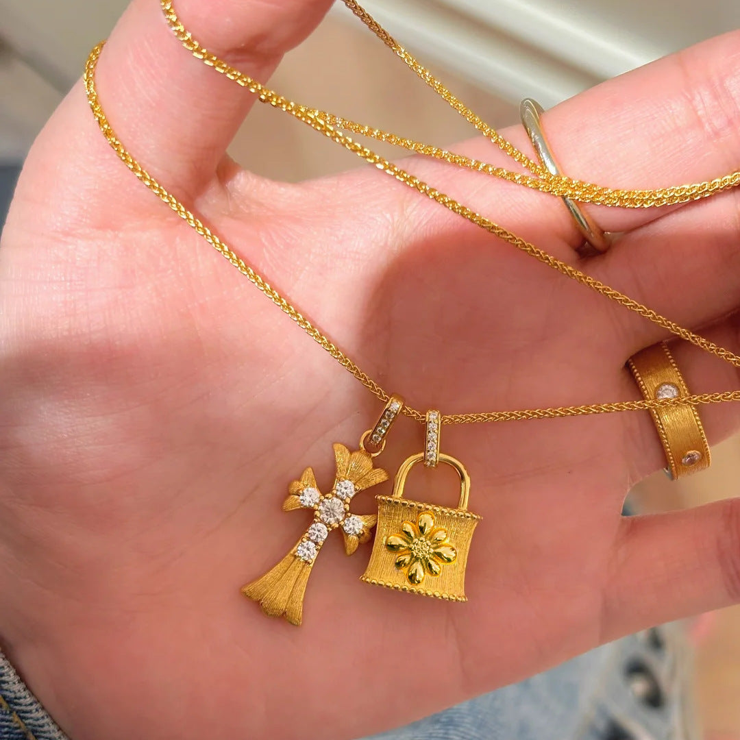 Cross-shaped brushed silver necklace with diamond accents